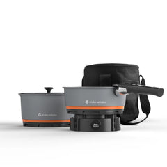 Stoke Voltaics Nomad pan sizzling on windy campsite for flavorful outdoor meals.