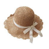 Wide-brim straw hat with lace bow on a woman