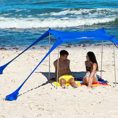 SUN NINJA beach tent open on the beach with sturdy poles for shade