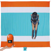 SUN NINJA sand-proof beach blanket folded in its travel bag for easy transport.