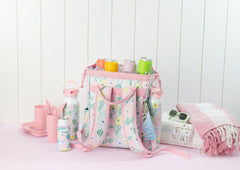 Swig Life Packi Backpack Cooler side view highlights side pockets for bottles and accessories.