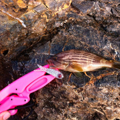 The Fish Grip Jr. Pink wrist lanyard image shows secure carry during fishing