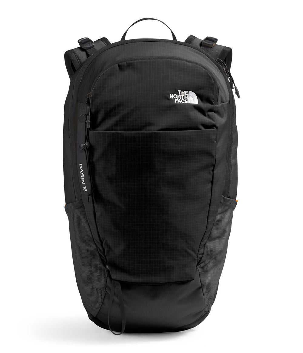 The North Face Basin 18L rain cover deployed for wet-weather hiking.