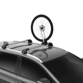 Thule Front Wheel Holder mounted on a roof rack securing a wheel for transport.