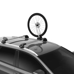 Thule Front Wheel Holder mounted on a roof rack securing a wheel for transport.