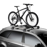 Thule ProRide XT on a vehicle roof showing universal compatibility with most racks.