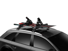 Thule SnowPack Large securing snowboards for safe rooftop transport.
