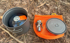 TOAKS bail-handle pot in camp, ideal for hanging over embers.