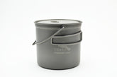 TOAKS titanium 1100ml bushcraft pot with bail handle, ready for open-fire cooking.