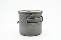 TOAKS titanium 1100ml bushcraft pot with bail handle, ready for open-fire cooking.