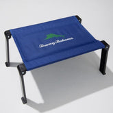 Tommy Bahama Ultra Compact Fabric Beach Folding Table on sand offers a stable snack surface.