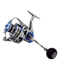 TSUNAMI ARMR spinning reel on beach, durable hybrid aluminum body withstands salt and sand.