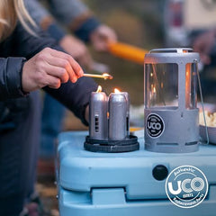 UCO 15-Hour Emergency Candle in camping scene provides warm ambient light
