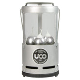 UCO Candlelier silver lantern glows warmly at campsite