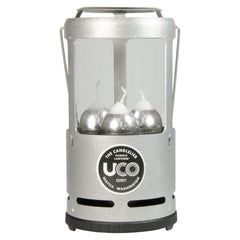 UCO Candlelier silver lantern glows warmly at campsite