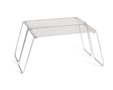 Vargo Titanium Bifold Grill setup over campfire for quick cooking