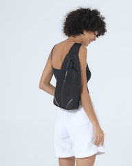 Waterfly sling backpack side pocket shows organized storage for daily essentials