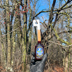 Buck-Fire Raging Estrus pour-spout bottle for easy scent application in field.