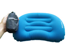 Wisemen Outdoors ultralight pillow on a sandy beach for cushioned rest.