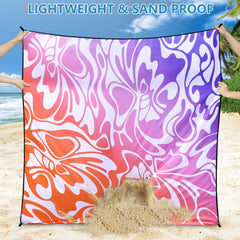WIWIGO Beach Blanket with anchor stakes securing it on windy beach