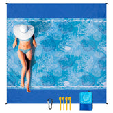 WIWIGO Beach Blanket on sand with four stakes anchors for wind-resistant stability.