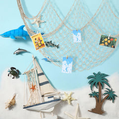 Wowangce fish netting coastal backdrop for pirate or ocean-themed parties adds visual depth.