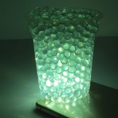 ZXJJ 9mm glass bullets create striking reflections in lighting setups.