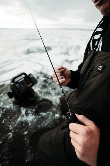 13 FISHING Tickle Stick in hand on ice for confident control.