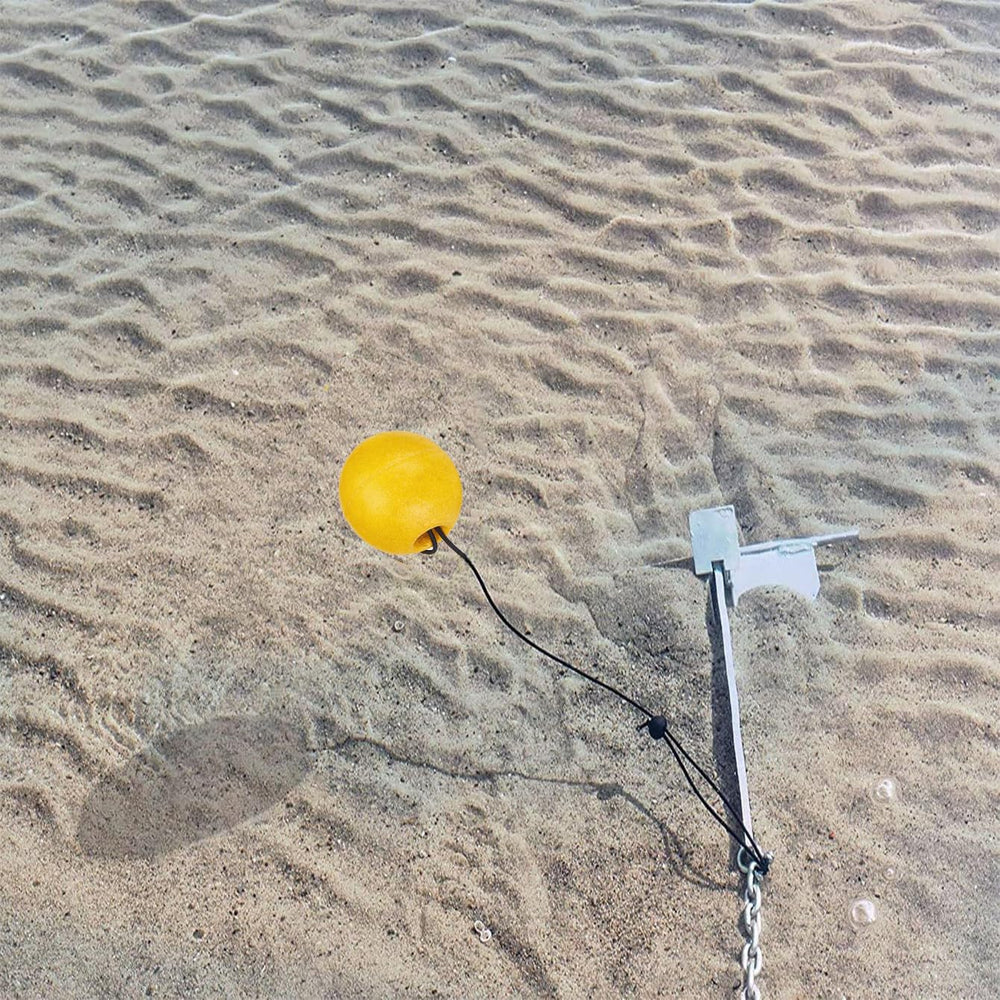 Yellow anchor buoy floating near a beach to improve visibility