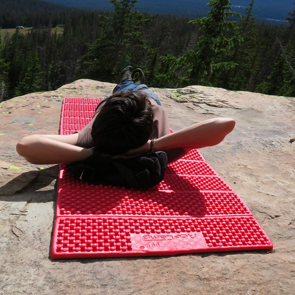 AceCamp portable foam sleeping pad unfolded provides full-length cushioning on rough campsites.