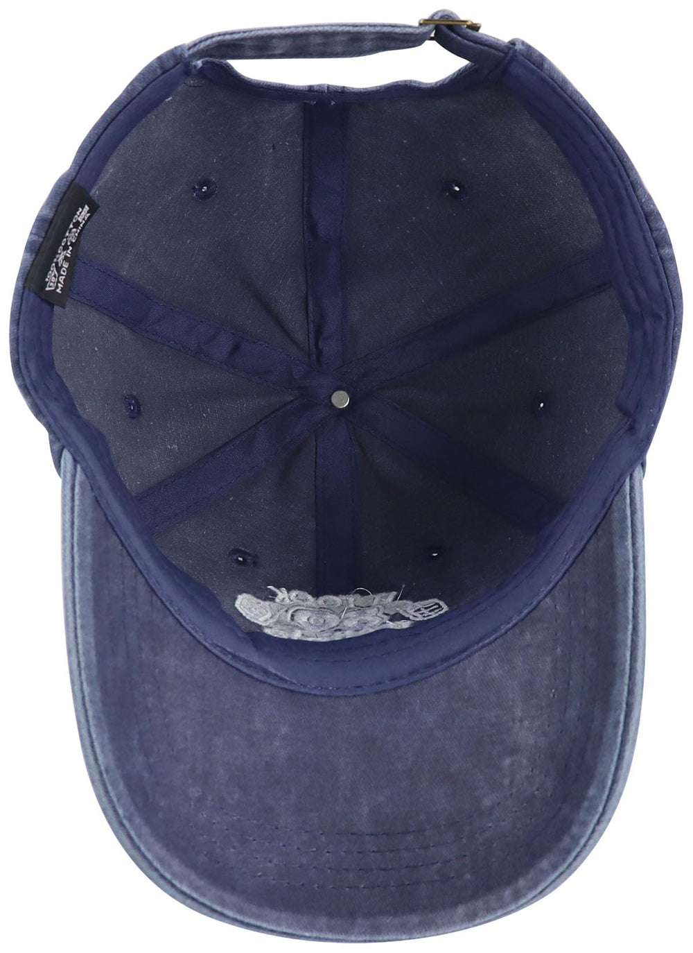 Close-up of adjustable tuck strap and slide closure on the cap
