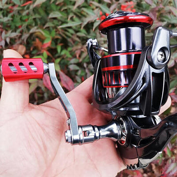 Close-up of red large-size fishing reel handle made of aluminum alloy