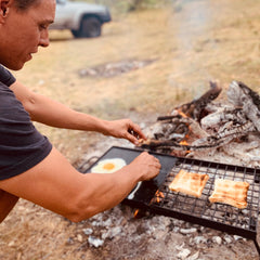 Adventure Seeka Campfire 24in grill-griddle half-open showcases grilling and griddling in one unit.