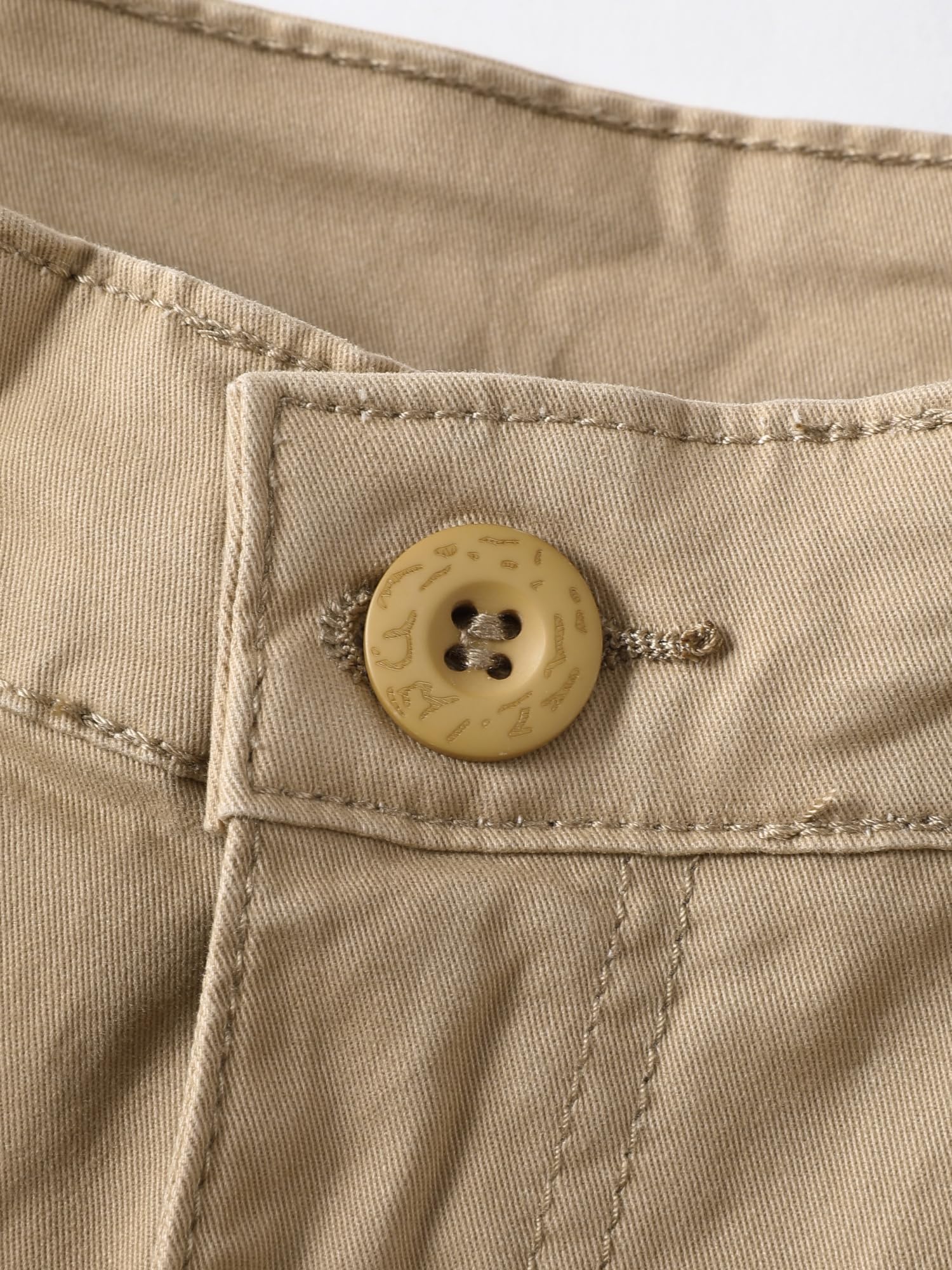 AKHIKING pants detail highlights sturdy zipper and buttons for rugged wear.
