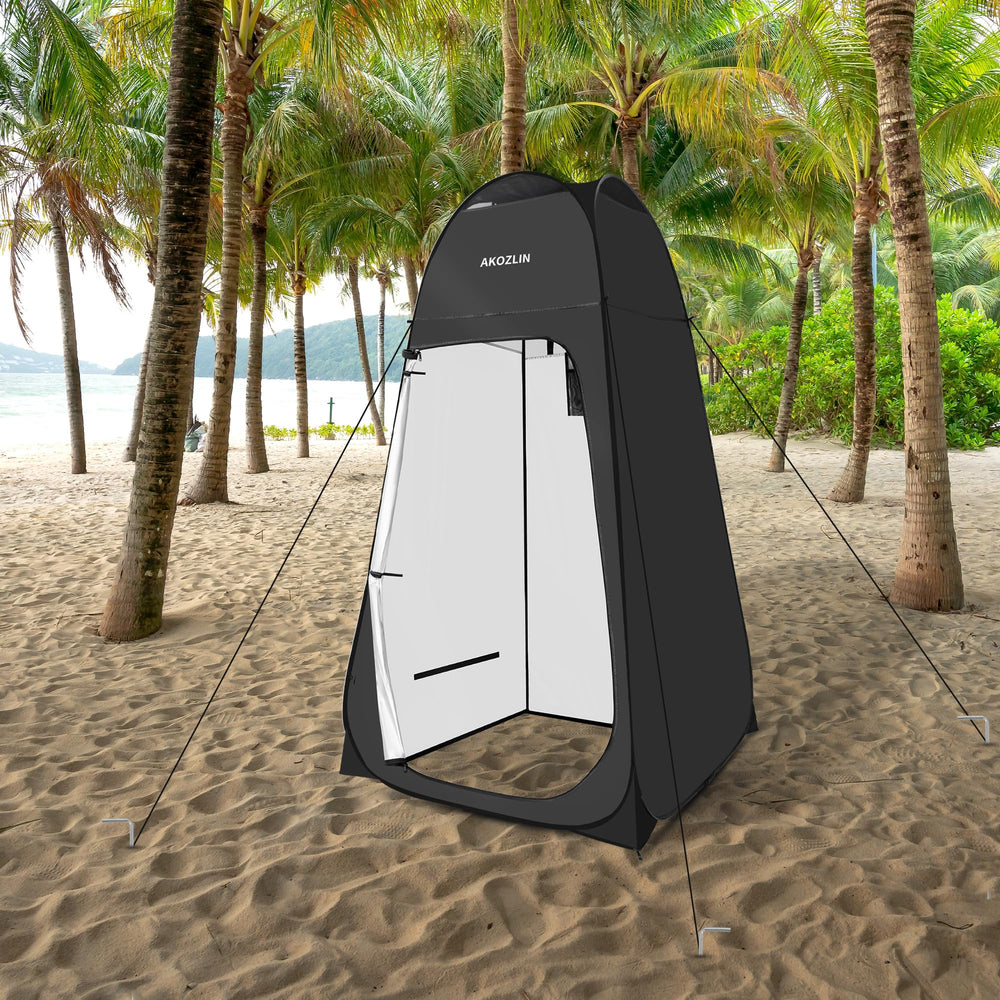 AKOZLIN portable pop-up shower tent beach scene emphasizes portability.
