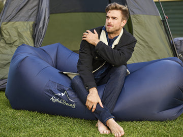 AlphaBeing lounger navy folded compact illustrates easy transport and storage.
