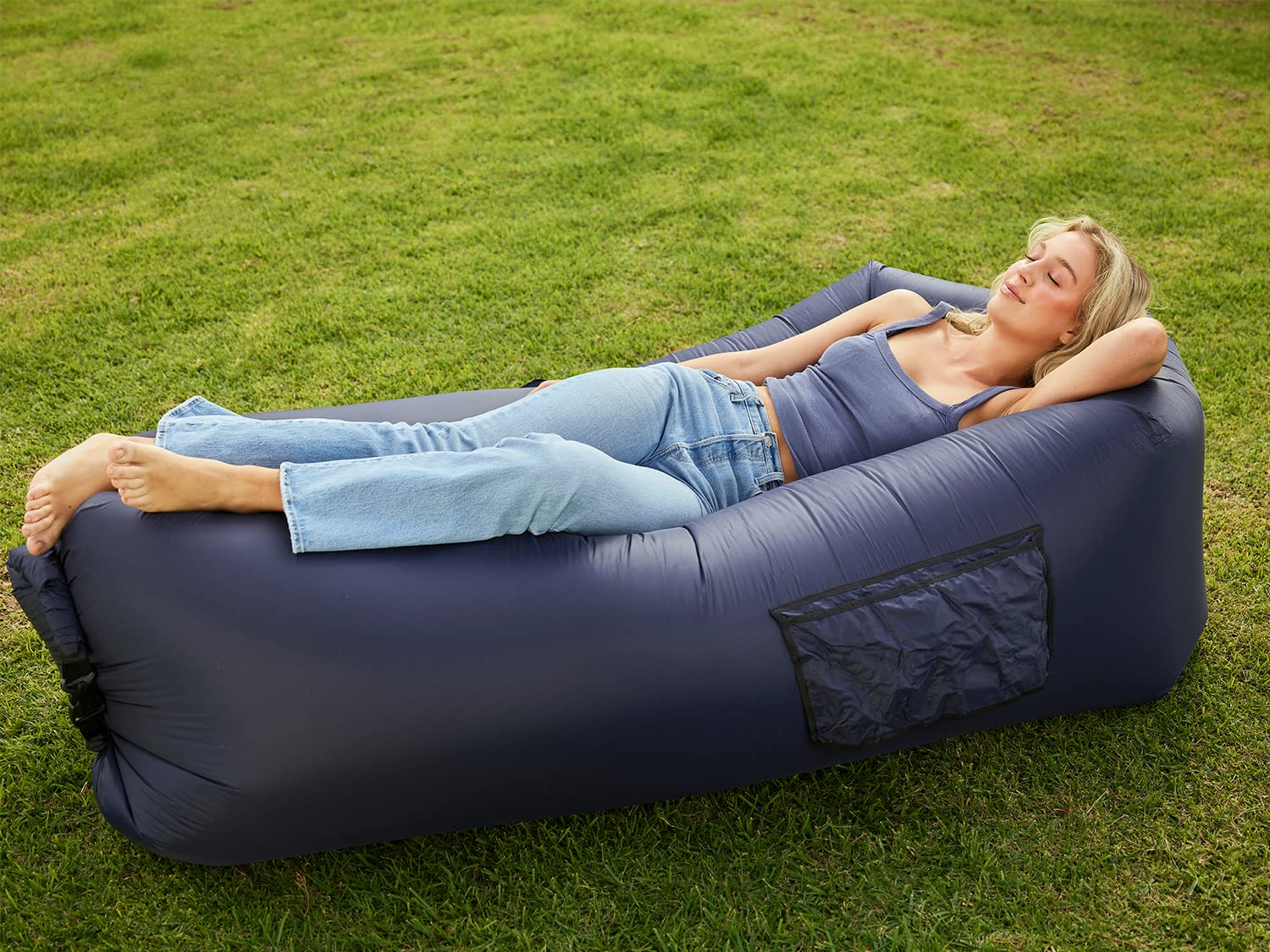 AlphaBeing inflatable lounger navy in use at the beach for comfortable, shade-free lounging.