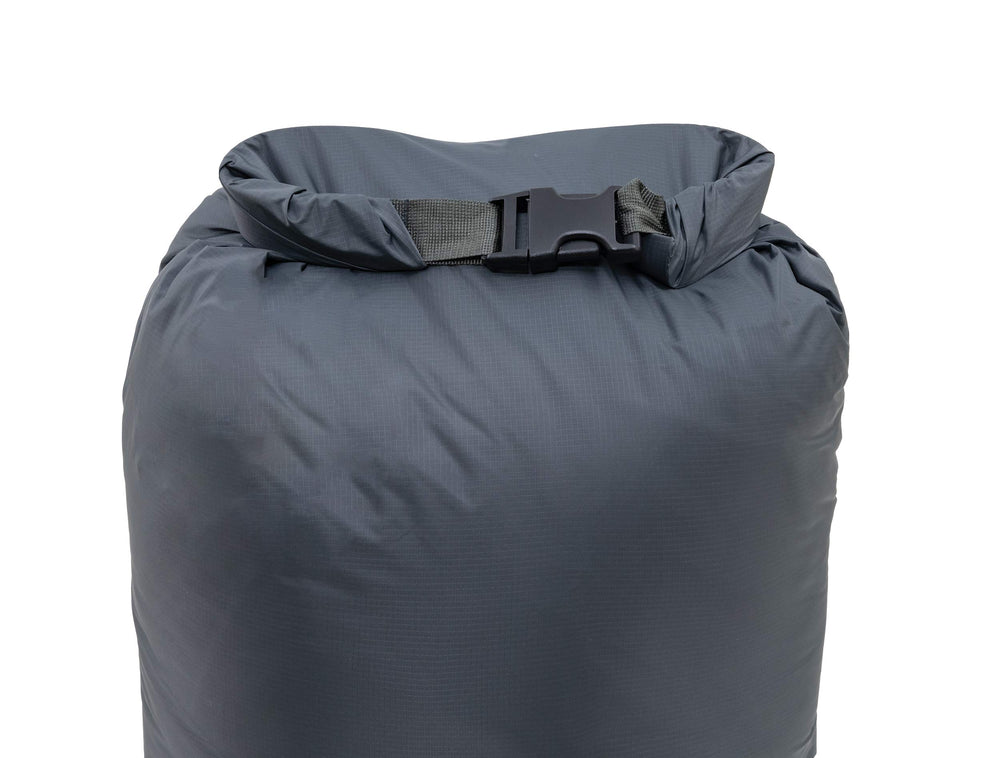 ALPS Mountaineering Dry Sack 45L blue gray during compression demonstrates air permeable bottom for venting air