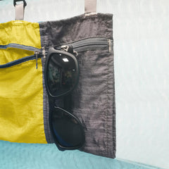 Amagogo Hammock Organizer Bag yellow hanging between poles for on the go storage