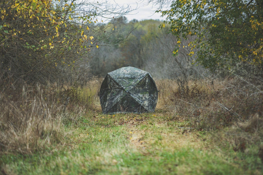 Ameristep Care Taker Mossy Oak DNA XL camouflage blends with terrain.