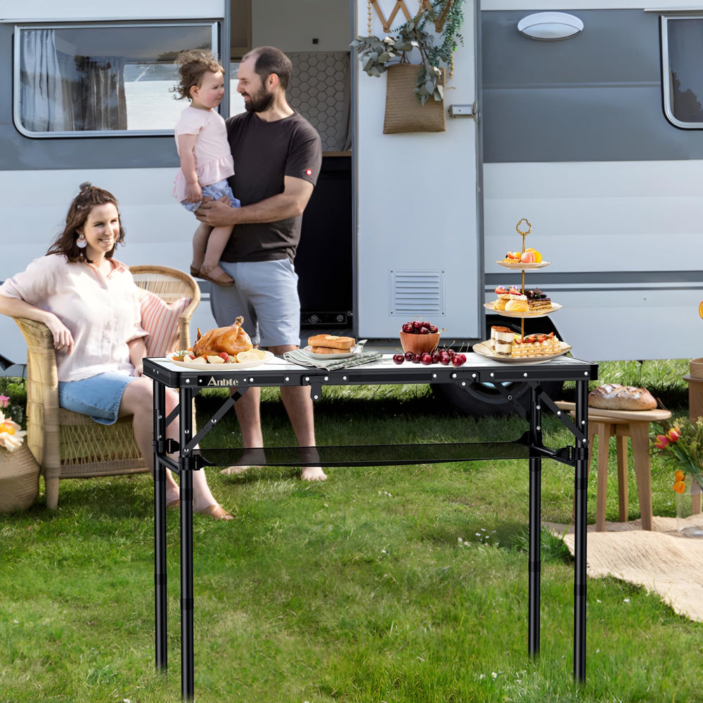 Anbte folding camping table with a carrying handle ready for quick transport and setup.