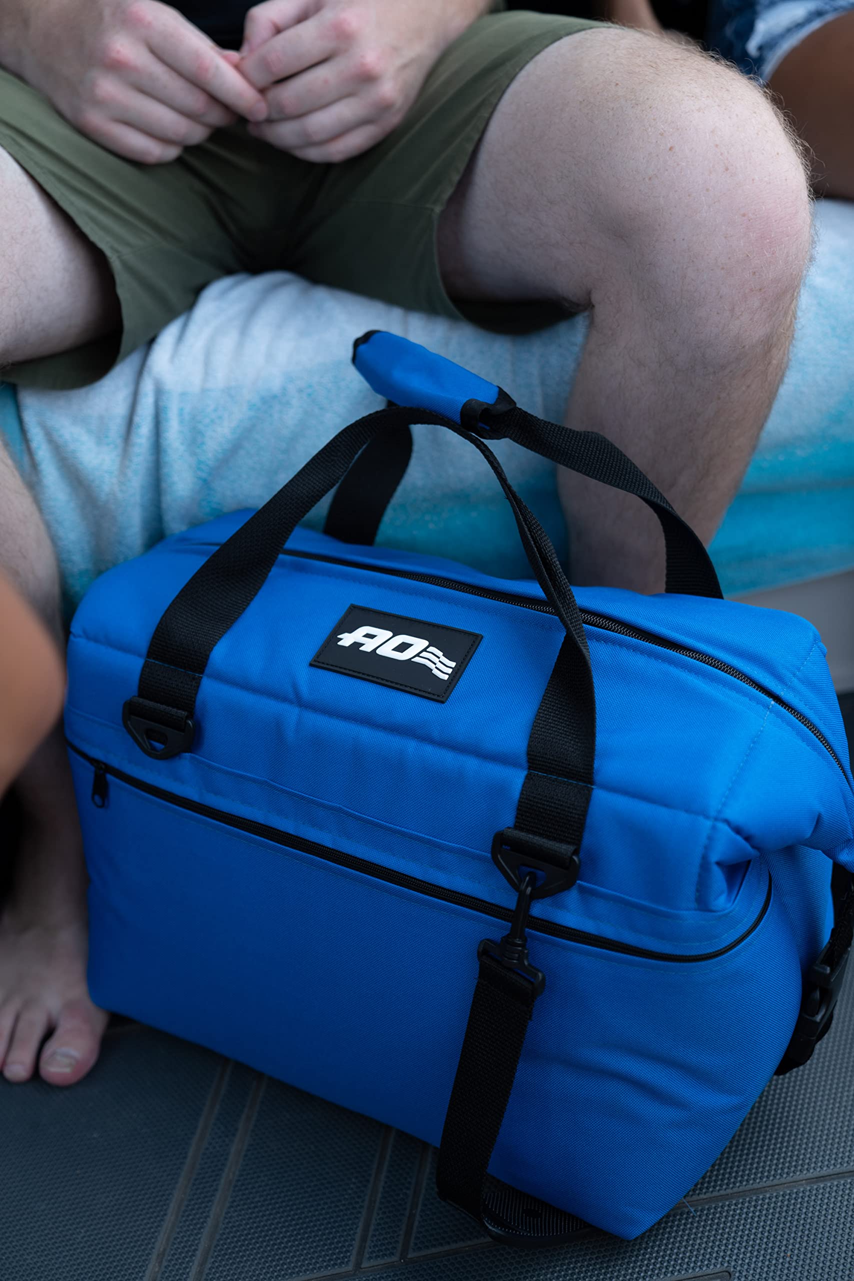 AO Coolers Traveler adjustable shoulder strap provides hands-free carrying.