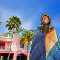 APSMILE outdoor down blanket worn as cloak shown with snaps for versatile warmth