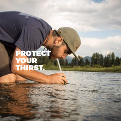 Aquamira Frontier emergency filter straw on hiking gear, ready for emergencies.