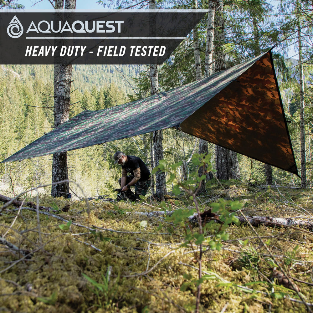 AquaQuest Defender Tarp woodland camo coverage highlights stealthy, durable shelter in nature.