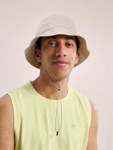 Arc'teryx Sinsolo bucket hat redesign wind test on a breezy trail