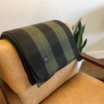 Arcturus Backwoods Wool Blanket on couch shows versatile home comfort and durability.