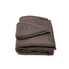 Arcturus Military Wool Blanket on campsite at dusk, offering generous warmth for two.