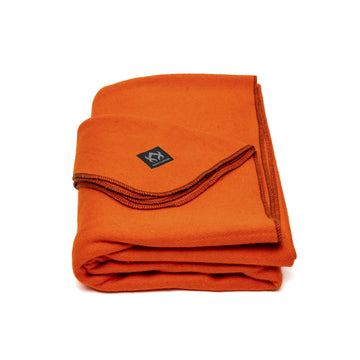 Arcturus Military Wool Blanket folded for portable warmth on outdoor trips.