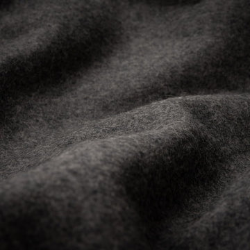 Arcturus loom-woven blanket close-up with durable contrast stitching.